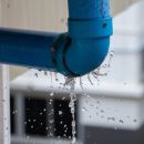 A close up of a blue burst pipe