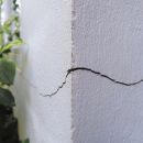 Cracked concrete building broken wall at the outside cement corner that effected with earthquake and collapsed ground