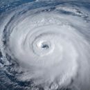 An aerial view of a hurricane passing over the ocean.