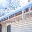 A close up of a roof with a small ice dam