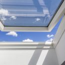 A closeup of an open skylight letting in natural air and improving ventilation at home